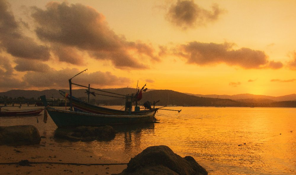 Boats on calm water at sunset off Koh Samui Boats on calm water at sunset off Koh Samui